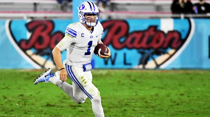 Zach Wilson holding a football